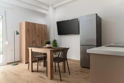 a kitchen with a table with chairs and a refrigerator at Athens Urban Vibes 5 Cozy Balcony Renovated in Athens