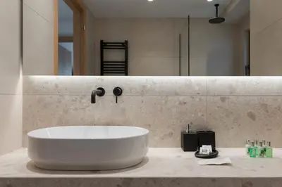 a bathroom with a large white tub on a counter at Glyfada Signature Apartment in Athens