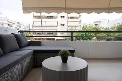 a living room with a couch and a table at Glyfada Signature Apartment in Athens