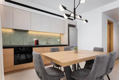 a dining room with a wooden table and chairs at Glyfada Signature Apartment in Athens