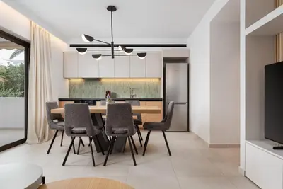 a kitchen and dining room with a table and chairs at Glyfada Signature Apartment in Athens