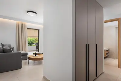 a living room with a couch and a table at Glyfada Signature Apartment in Athens