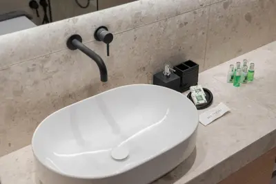 a bathroom with a white sink in a counter at Glyfada Signature Apartment in Athens