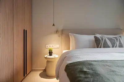 a bedroom with a bed and a night stand with a plant on it at Glyfada Signature Apartment in Athens