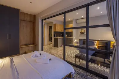 a bedroom with a bed and a large window at Cozy loft at Little Kook's alley, Psirry heart in Athens
