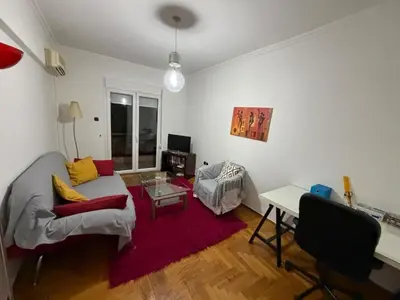 a living room with a couch and a table at Athens central apartment in Athens