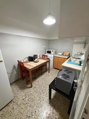a small kitchen with a table and a stove at Athens central apartment in Athens