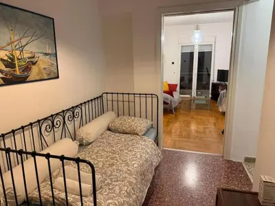 a bedroom with a bed and a living room at Athens central apartment in Athens