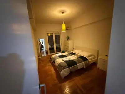 a bedroom with a bed in the middle of a room at Athens central apartment in Athens