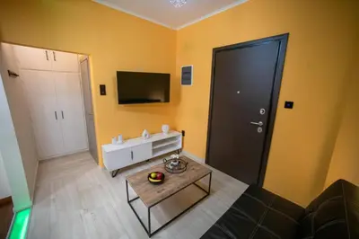 a living room with a black door and a table at Smart Studio with Self Check-in in Athens