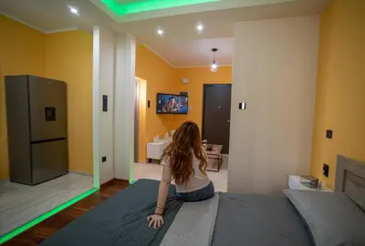 a woman sitting on a bed in a room at Smart Studio with Self Check-in in Athens