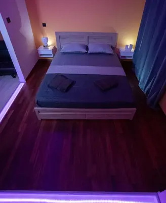 a bedroom with a large bed with blue sheets at Smart Studio with Self Check-in in Athens