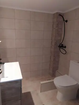 a bathroom with a toilet and a shower at A perfect place - close to Acropolis & Seacoast in Athens
