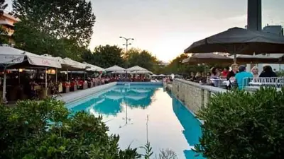 a large swimming pool with people sitting around it at A perfect place - close to Acropolis & Seacoast in Athens