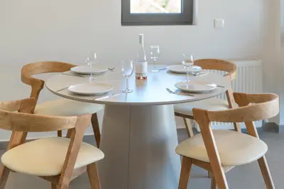 a white table with chairs and wine glasses on it at M58 Pool Residence - Glyfada Central - Miltiadou 58 by K&M in Athens