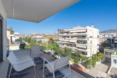 a balcony with chairs and a table and a view at M58 Pool Residence - Glyfada Central - Miltiadou 58 by K&M in Athens