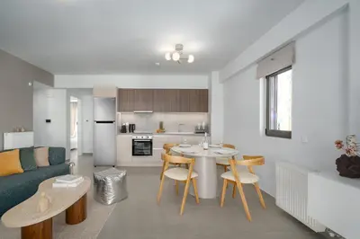 a kitchen and living room with a table and chairs at M58 Pool Residence - Glyfada Central - Miltiadou 58 by K&M in Athens