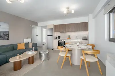 a living room and kitchen with a couch and a table at M58 Pool Residence - Glyfada Central - Miltiadou 58 by K&M in Athens