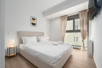 a bedroom with a bed and a large window at M58 Pool Residence - Glyfada Central - Miltiadou 58 by K&M in Athens