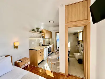 a room with a bed and a kitchen and a bathroom at Rooftop Oasis - Design Studio with Acropolis View in Athens