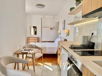 a kitchen and living room with a bed in the background at Rooftop Oasis - Design Studio with Acropolis View in Athens