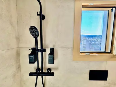 a shower with a blow dryer in a bathroom at Rooftop Oasis - Design Studio with Acropolis View in Athens