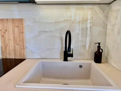 a sink in a kitchen with a faucet at Rooftop Oasis - Design Studio with Acropolis View in Athens