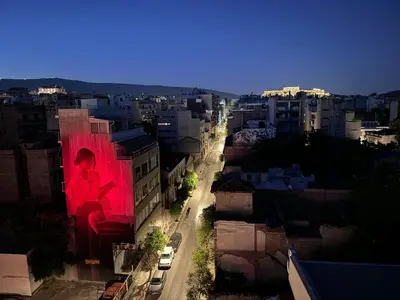 a building with a large painting of a person on it at Krezias Apartments K1 Acropolis View ! in Athens