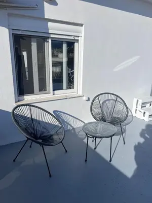 two chairs and a table in front of a window at Krezias Apartments K1 Acropolis View ! in Athens