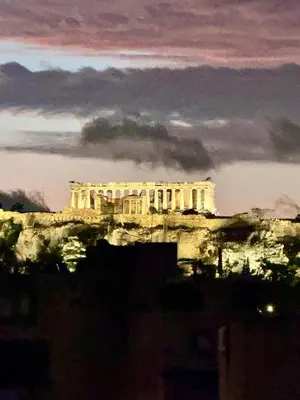 a building on top of a hill at night at Krezias Apartments K1 Acropolis View ! in Athens