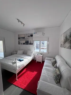 a white bedroom with a bed and a couch at Krezias Apartments K1 Acropolis View ! in Athens