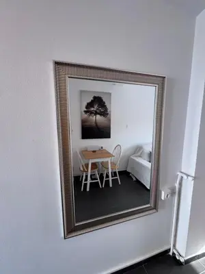 a mirror on a wall with a table in a room at Krezias Apartments K1 Acropolis View ! in Athens