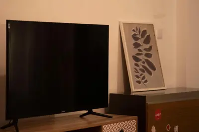 a flat screen tv sitting on top of a wooden table at Cozy Gem in Athens in Athens