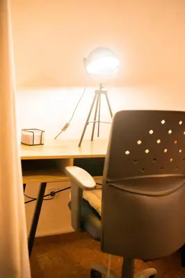 a desk with a chair and a lamp on a desk at Cozy Gem in Athens in Athens