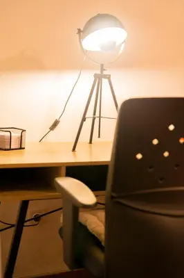 a desk with a chair next to a desk with a light at Cozy Gem in Athens in Athens