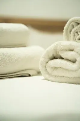 a stack of white towels on a table at Cozy Gem in Athens in Athens