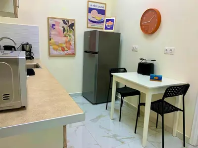 a kitchen with a white table and a refrigerator at Citrus in Athens