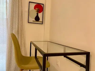 a glass table and a yellow chair in a room at Citrus in Athens