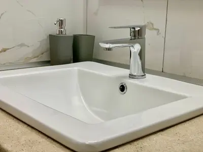 a white sink with a faucet in a bathroom at Citrus in Athens