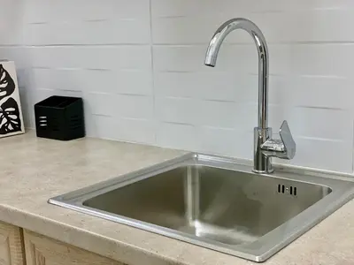 a kitchen sink with a faucet on a counter at Citrus in Athens