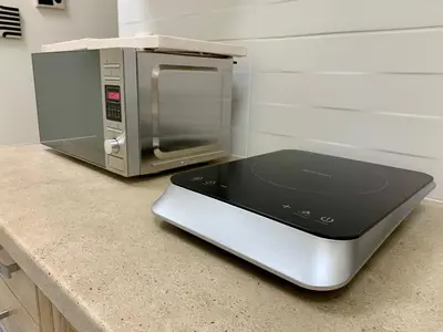 a toaster oven sitting on a counter next to a microwave at Citrus in Athens