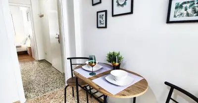 a dining room table with two glasses of wine at One bedroom apartment in Thissio in Athens