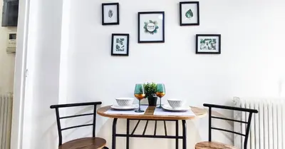 a table with two chairs and two glasses of wine at One bedroom apartment in Thissio in Athens