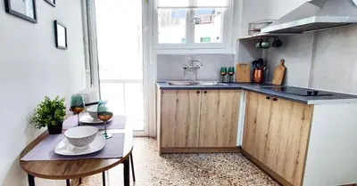 a kitchen with a table with two glasses of wine at One bedroom apartment in Thissio in Athens