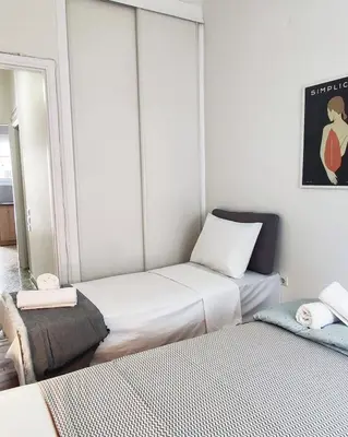 a small room with two beds and a mirror at One bedroom apartment in Thissio in Athens