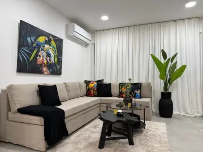 a living room with a couch and a table at Beachfrond apartment in Voula in Athens