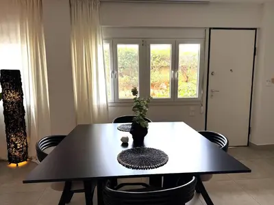 a dining room table with a plant on top of it at Beachfrond apartment in Voula in Athens