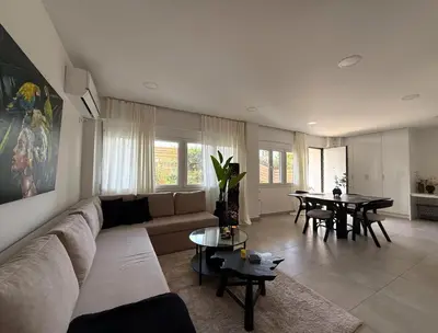 a living room with a couch and a table at Beachfrond apartment in Voula in Athens