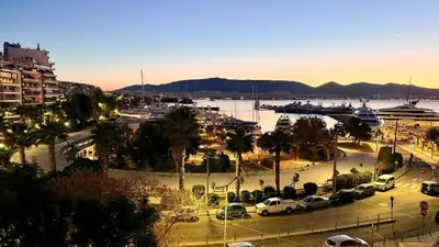 a view of a harbor with cars parked in a parking lot at Promenade Piraeus in Piraeus