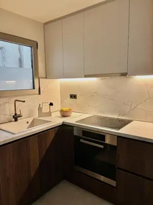 a kitchen with a sink and a stove top oven at Brand New Apartment next to Varkiza Beach in Vari